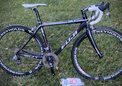 A black and white bike sitting on the grass.