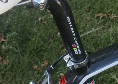 A close up of a bicycle with a carbon seat post.